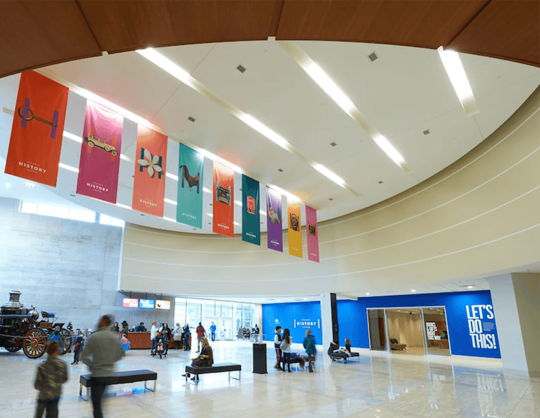 The Atlanta History Center’s interior atrium featuring large hanging banners of historic artifacts, inviting visitors into immersive exhibits.