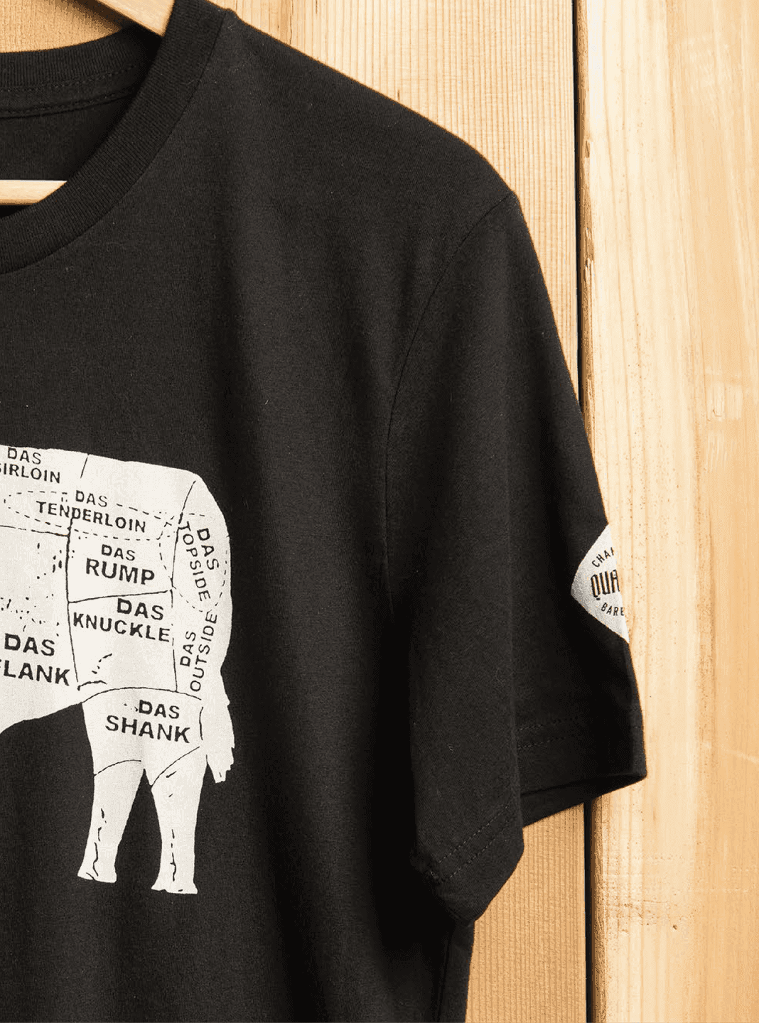 DAS BBQ T-Shirt. A black tee printed with the DAS BBQ butcher-style cow diagram.