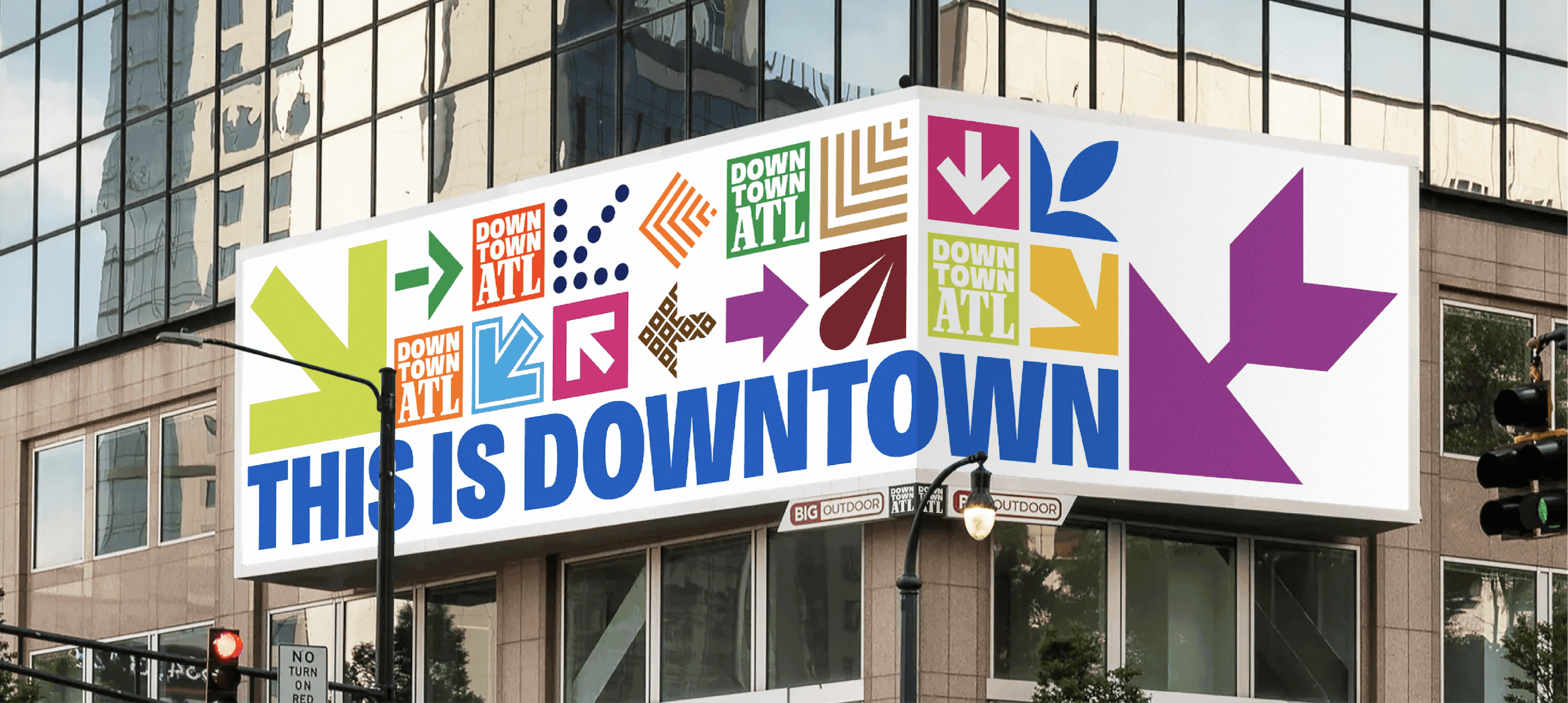 Downtown ATL Directional Billboard. A large Downtown ATL billboard displays colorful arrows and icons above the message “This Is Downtown.”
