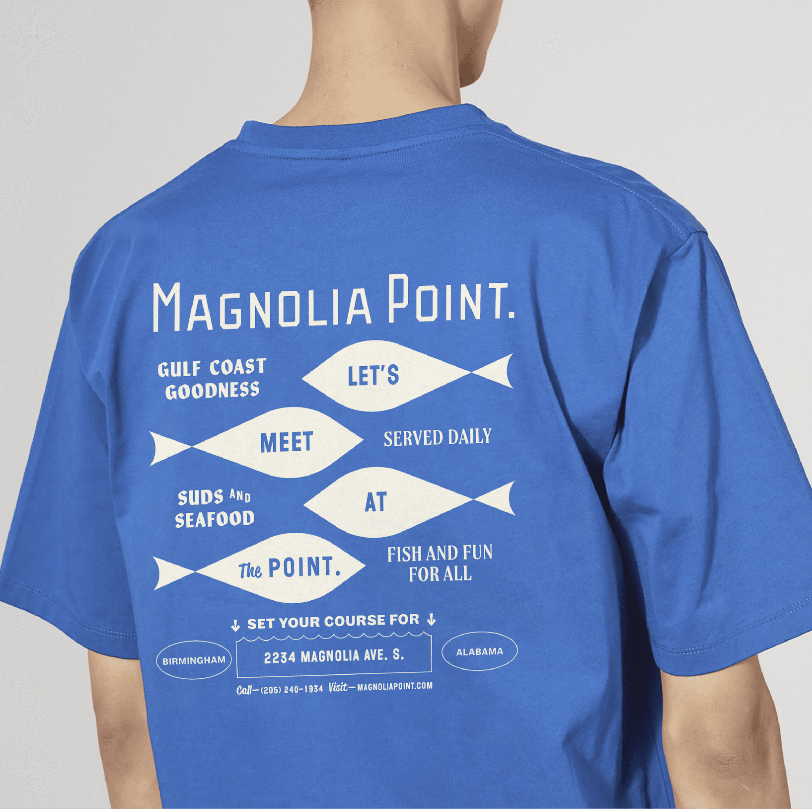 Blue t-shirt back print. A Magnolia Point t-shirt with a back graphic featuring fish illustrations and playful menu-inspired text.