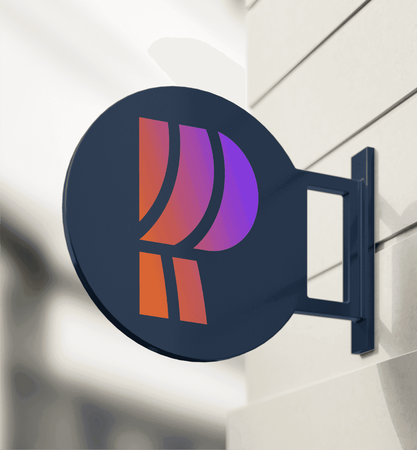 Exterior Signage. A metal sign featuring the PRIA monogram adds a polished, modern presence to the built environment.
