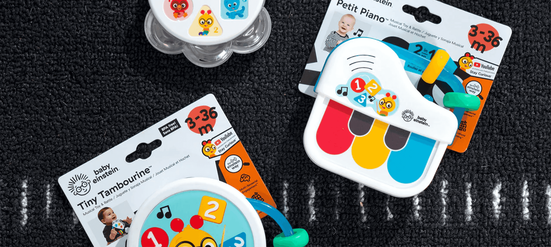 Baby Einstein musical toys on display. Baby Einstein toddler instruments—including a tambourine and mini piano—shown in vibrant packaging.